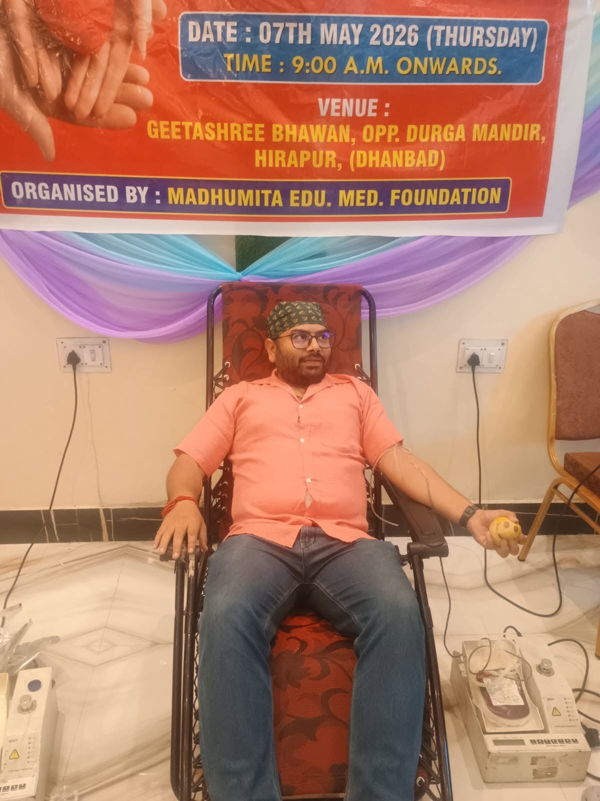A donor giving blood, holding a stress ball