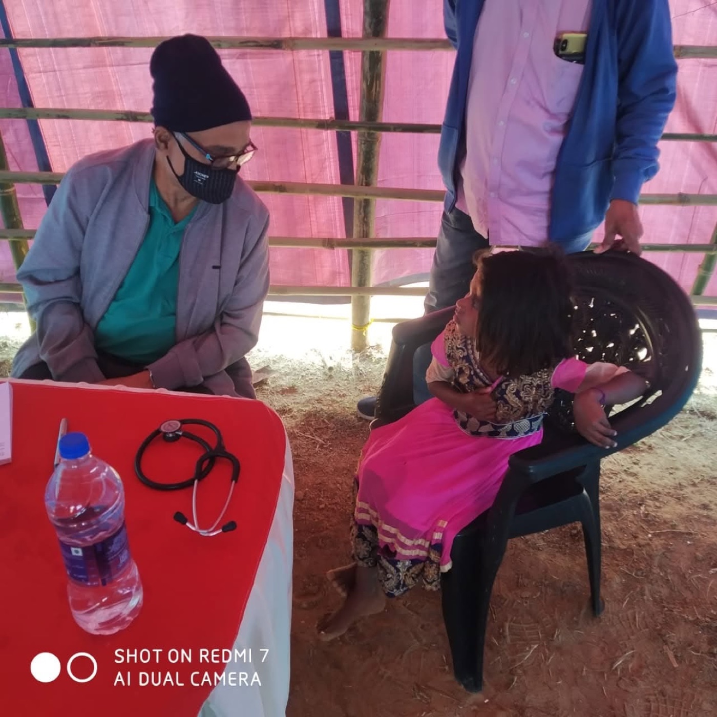 Doctors consulting families at a free medical camp